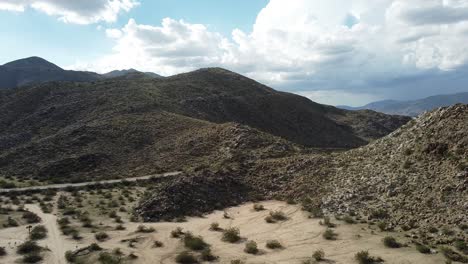 Aerial:-A-road-in-the-middle-of-the-desert-landscape-in-San-Diego,-California