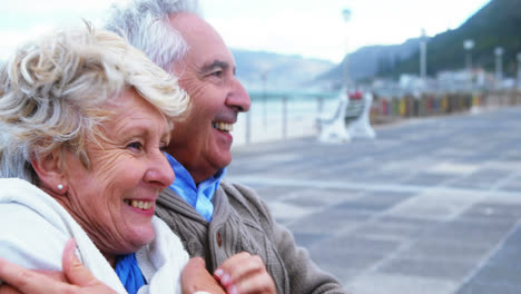 Senior-couple-interacting-with-each-other-at-the-beach