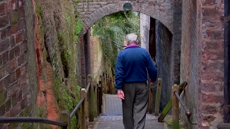 old man walking down steps in bridgnorth, in the united kingdom both color and black and white versions from 5, 10, 15 seconds to long version