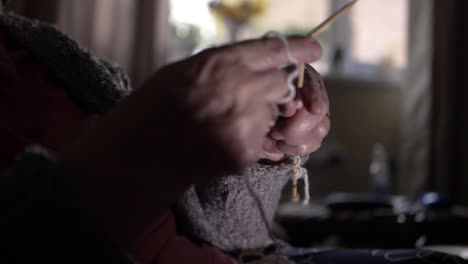 elderly lady's hands at home knitting medium shot