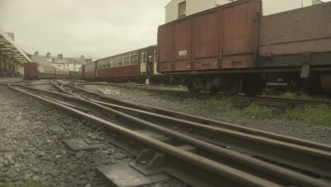 ffestiniog railway track leads the eye to a stream train cross in the background