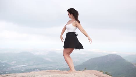woman performing yoga pose in mountain landscape