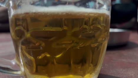 Close-up-of-glass-of-beer-on-floor