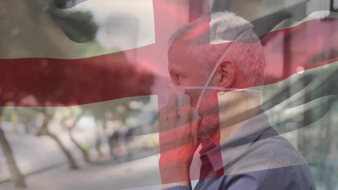 animación de la bandera de inglaterra ondeando sobre un hombre que usa una máscara facial durante la pandemia de covid-19