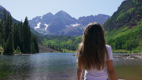 maroon bells aspen snowmass wilderness hike shoreline lake women female model actress peaceful reflective wonder 14er capital peaks rocky mountains colorado summer stunning morning cinematic pan