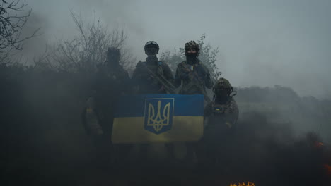 ukrainian soldiers with flag in a foggy landscape