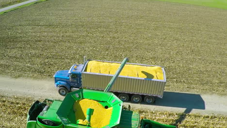 Excellent-aerial-over-a-rural-American-farm-with-corn-combine-harvester-at-work-1