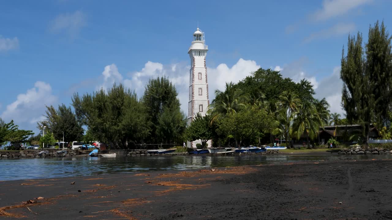 Famous black sand beach of Point Venus and its historic lighthouse in Papeete, Tahiti, French Polynesia.