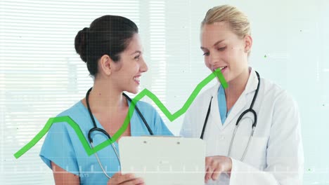 animation of financial graphs over happy caucasian female doctors talking