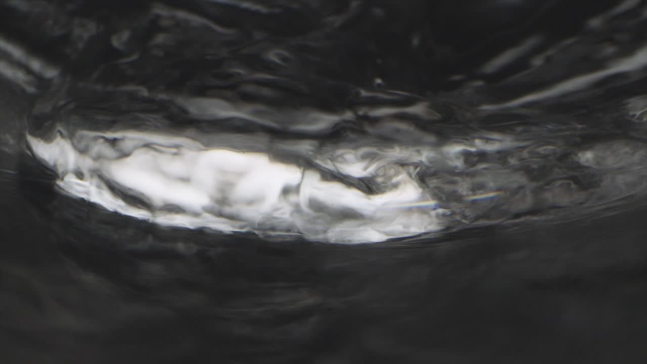 Macro footage of water filling a glass and Laowo lens becomes submerged shot with Sony F55 at 120fps