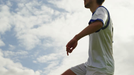 football player juggling a ball