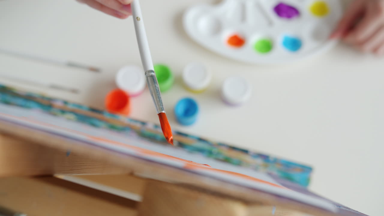 Child painting with a paintbrush