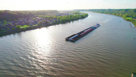 AERIAL---Pusher-boat-and-barge,-Ohio-River,-Ironton,-Ohio,-circling-shot