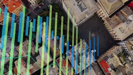 animación de gráficos multicolores sobre una vista aérea de edificios modernos