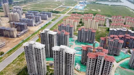 dynamic rotating dolly view of tall chinese skyscrapers under construction - cinematic aerial footage