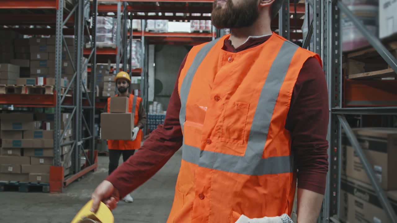 Male Warehouse Worker Putting Hard Hat On
