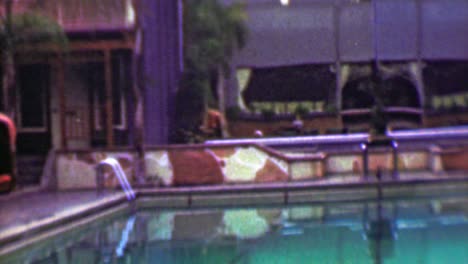 1958: hotel resort pool lounge chair relaxation vacation fun zone.