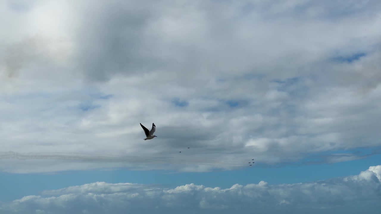 A vintage aircraft flies through cloudy skies during an aviation display at Gold Coast, Australia.