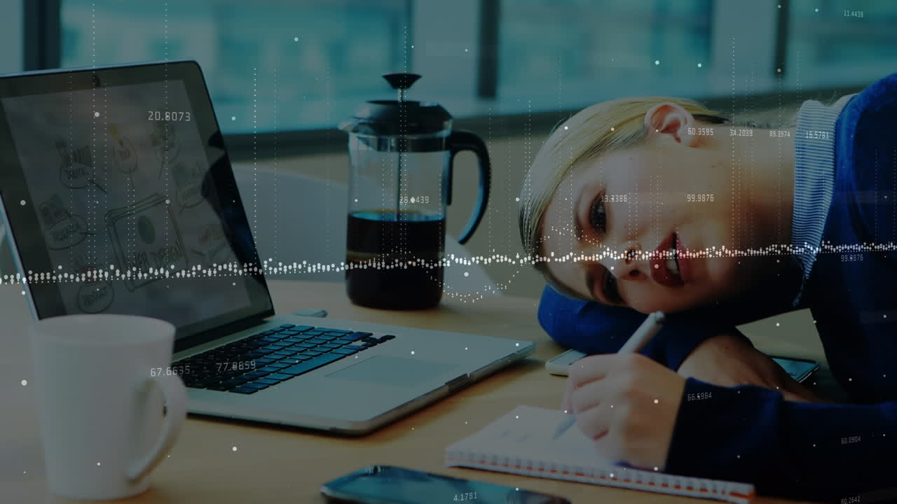 Animation of data processing over caucasian businesswoman taking notes at office