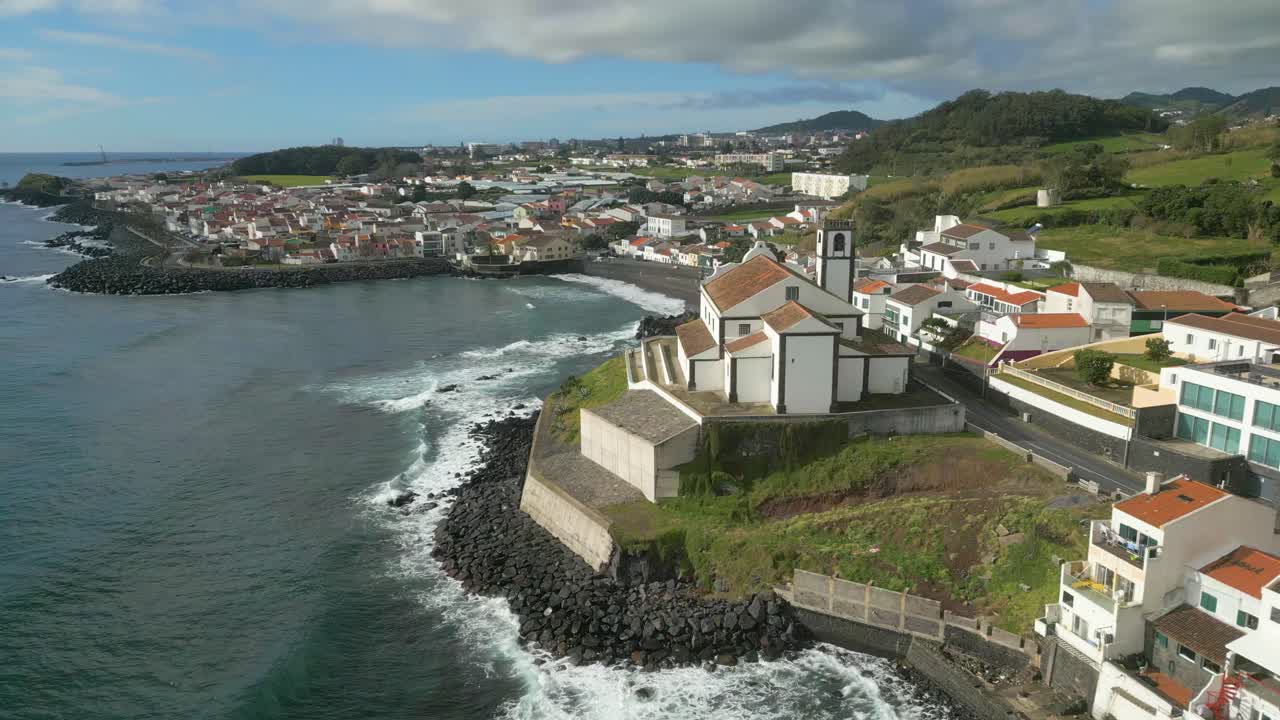 Coastline aerial view of Sao Roque Beach and its Church on Sao Miguel Island