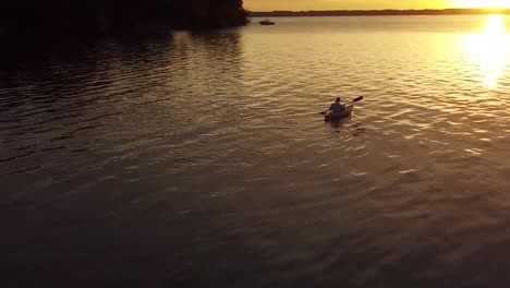 orbital drone over kayaker at sunrise on lake michigan