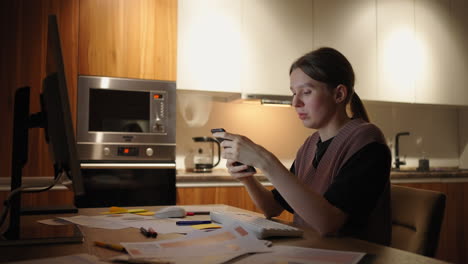 Woman-working-frome-home-business-female-working-on-laptop-and-using-mobile-phone-drinking-coffee-sitting-on-table-in-the-garden-in-morning.-Lifestyle-women-working-at-home-concept.