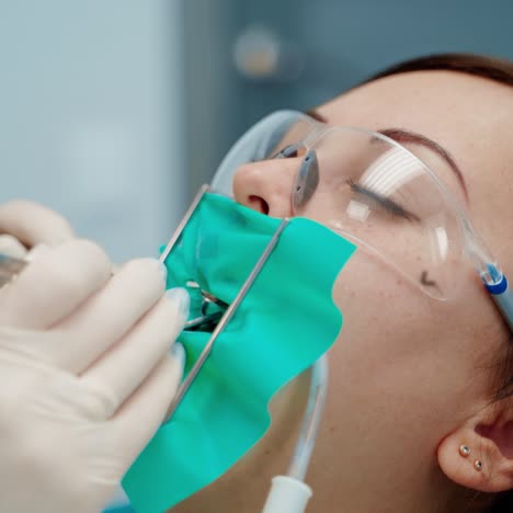 . young female at dentist office. close up medical dentist procedure of teeth