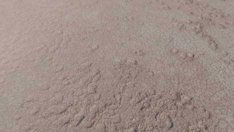 drone clip showing wide expanse of dry and cracked ground in outback desert in wa, australia