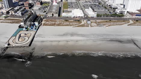 a side profile moving aerial view of the atlantic city beach and shoreline