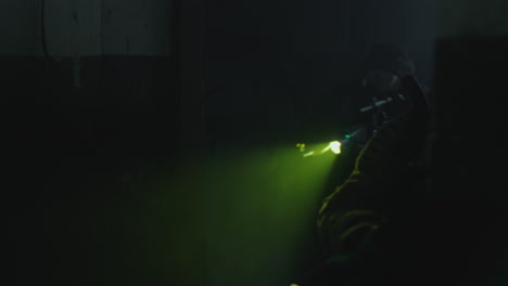 masked person in a dark room with a light