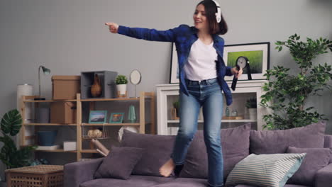 teenage girl dancing and singing at home