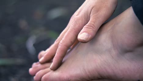 woman examining bruised ankle