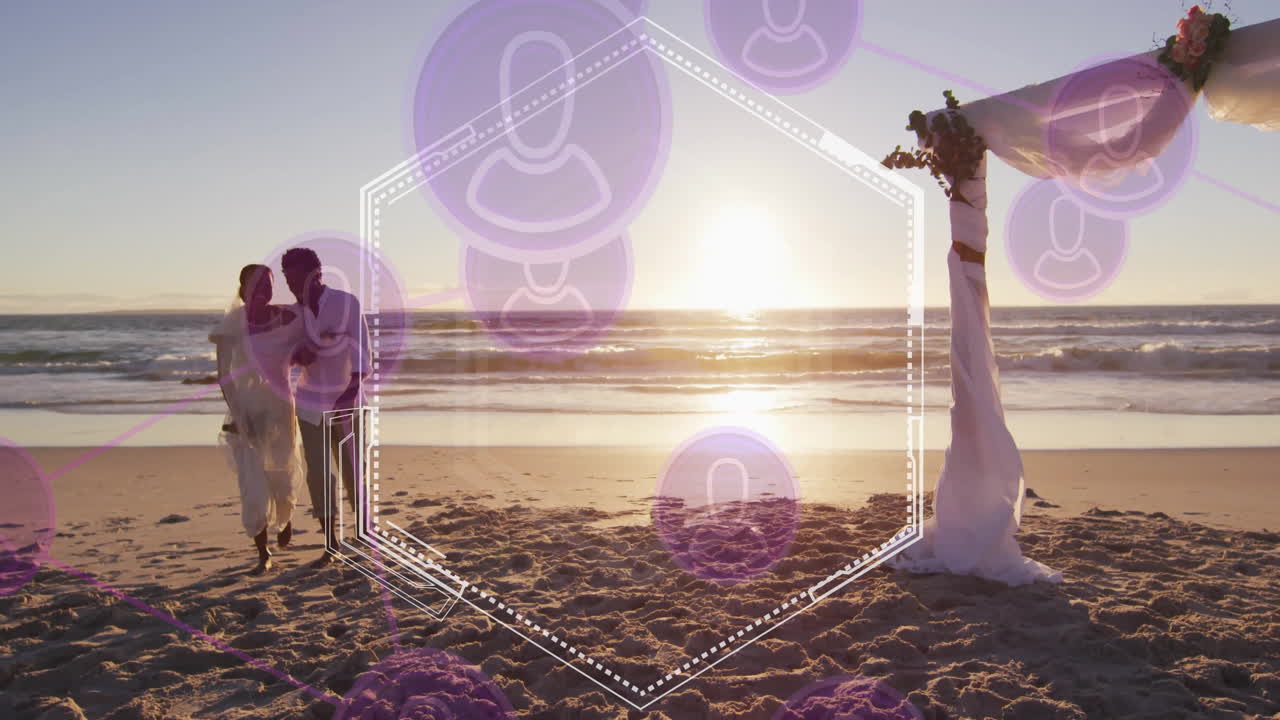 Couple embracing on beach at sunset with purple geometric animation overlay