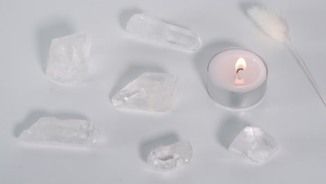clear quartz and a burning candle
