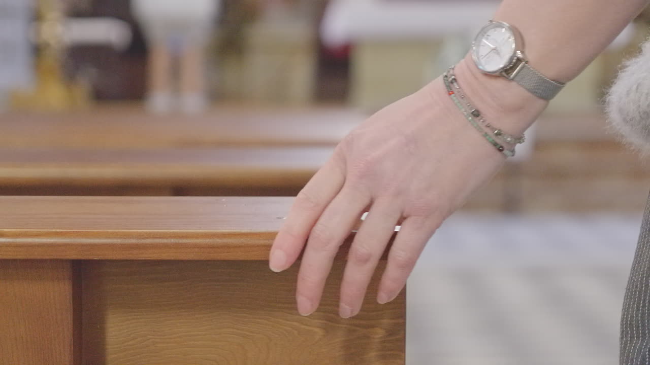 Female Hand Touches Church Bench when Walking in Aisle - Soft Focus CU