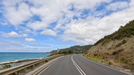 a 15-second video capturing a drive along the great ocean road, showcasing coastal views, winding roads, and lush greenery under a bright sky