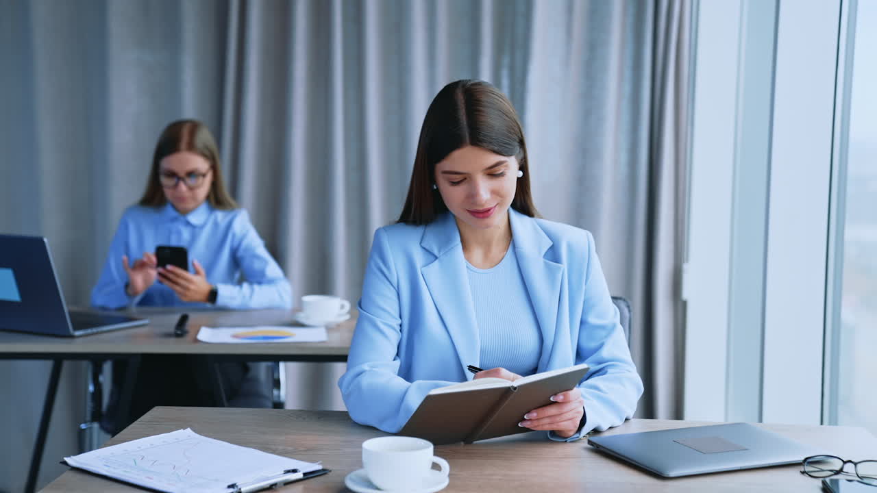 Two Businesswomen Working in an Office