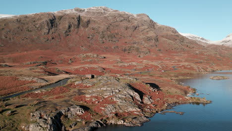 Winter-countryside-and-mountain-with-lake-and-snaking-road-at-Wasdale-Lake-District-UK