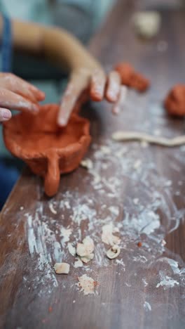child making a clay pot