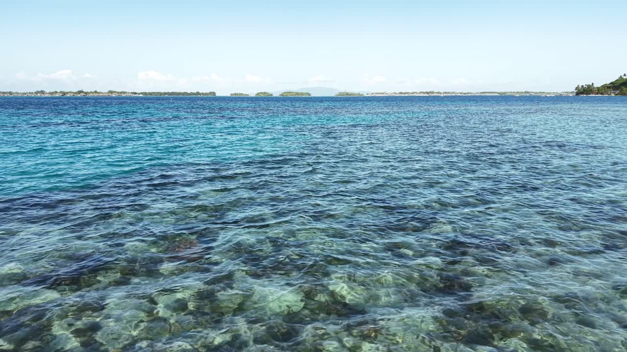 Flying Above Lagoon and Coral Reefs of Bora Bora Island, French Polynesia. Drone Shot