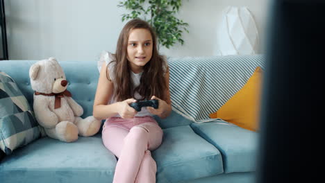 girl playing video games on couch