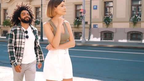 couple walking and hugging in city street