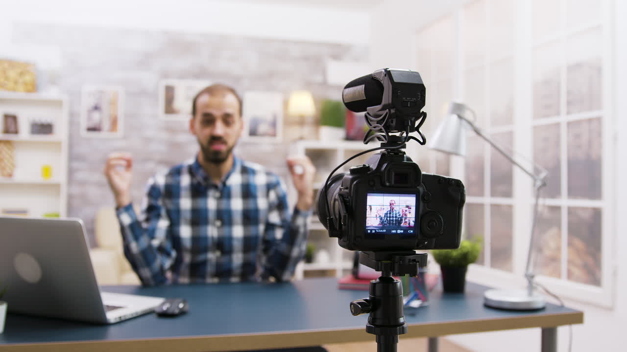 A camera filming a person vlogging at a table