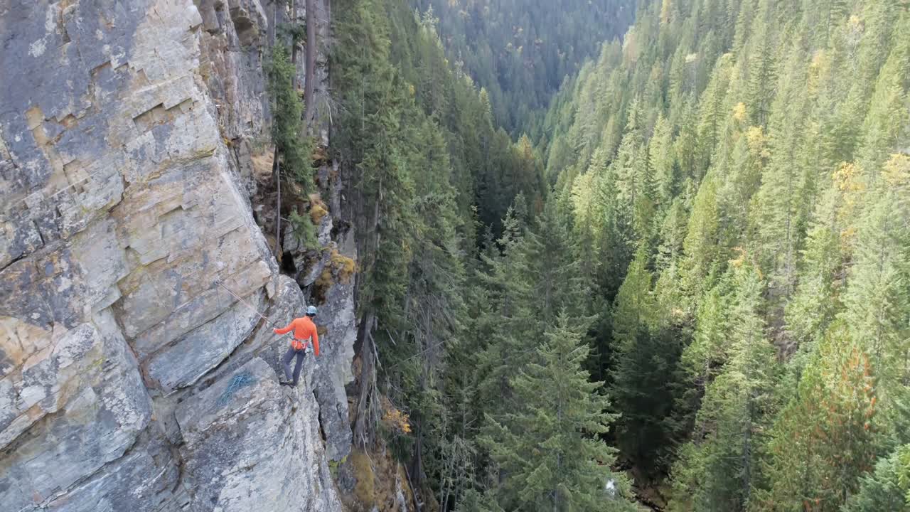 Climber climbing rocky mountain 4k