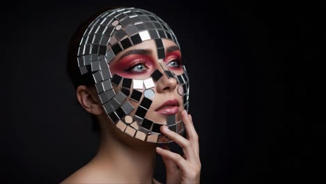 a stunning artistic transformation: a model adorned with shimmering makeup and a reflective mosaic face mask, captured in two striking frames