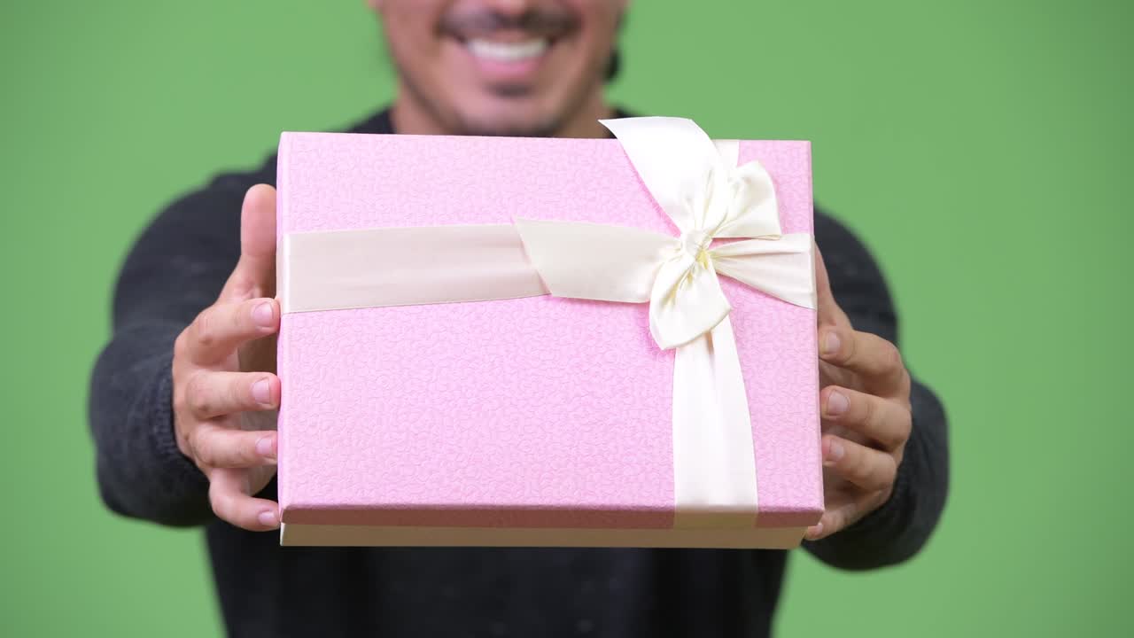 Happy handsome man giving gift box