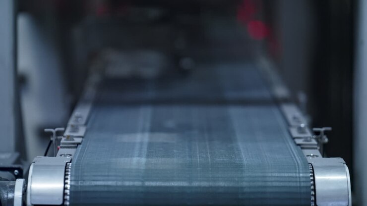 Tyre plant conveyor belt moving at technological automotive manufacture closeup