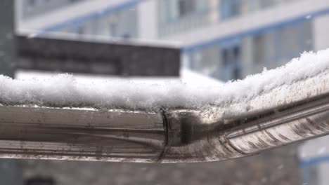 snow building up on a rail