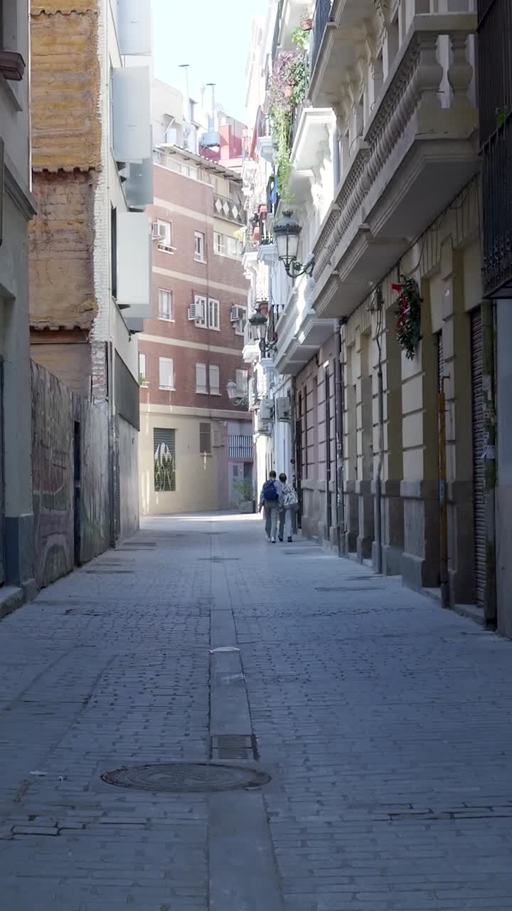 Narrow city street with people walking
