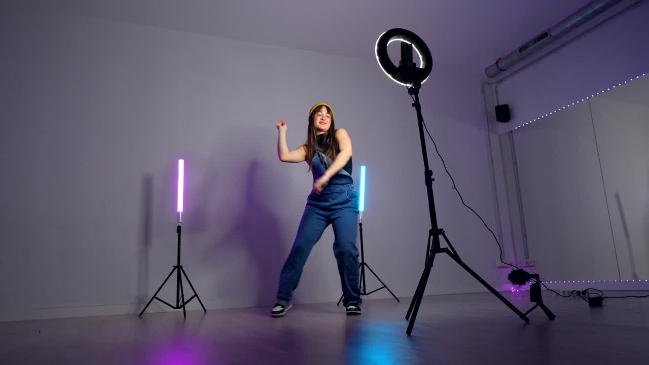 Woman Dancing in Studio with Ring Light and Light Tubes